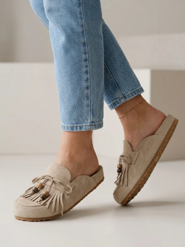 Nano Banana 2 - A realistic fashion lifestyle shot of a woman wearing beige suede mule slippers with_1.png