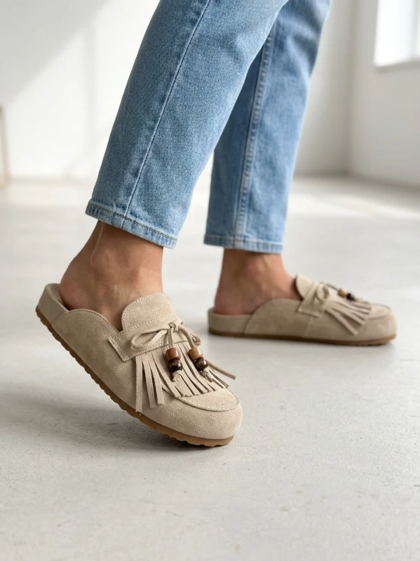 Nano Banana 2 - A realistic fashion lifestyle shot of a woman wearing beige suede mule slippers with_4.png